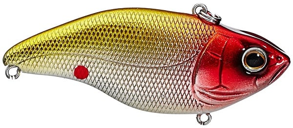 The SPRO Aruku Shad Lipless Crankbait resembles a fish with a metallic gold and red gradient body, detailed scales, and a realistic eye. It includes Gamakatsu treble hooks on metal loops and has a distinctive small red dot on its side.