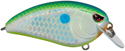 Close-up of SPRO's Spro Fat John 60 Crankbait, featuring a colorful green-yellow gradient top, blue-silver scale sides, red eyes, and a white plastic lip. Designed for shallow diving with sharp Gamakatsu treble hooks for optimal catch.
