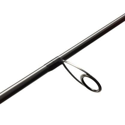 Close-up of a black St. Croix Avid Trek Travel Spinning Rod 7'6” Medium (ATS76MF3) with a metal guide ring and SCIII carbon construction, set against a plain white background.