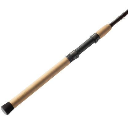 A close-up of the St. Croix Avid Trek Travel Spinning Rod 7'0” Medium Heavy handle, showing a cork grip, black reel seat, and rubber butt cap. Crafted with SCIII carbon for medium heavy action, isolated on a white background.