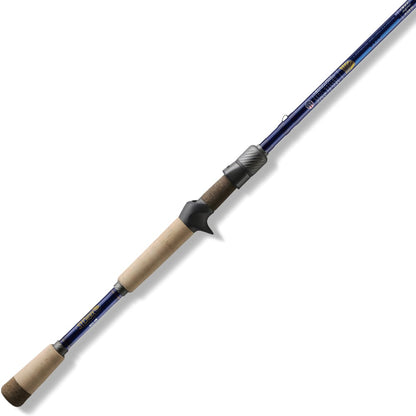 The St. Croix Legend Tournament Bass Casting Rod 7'2" Medium Finesse Glass Cranker (LBTC72MM) rests diagonally on a white background, featuring a blue shaft, light cork handle, and black reel seat.
