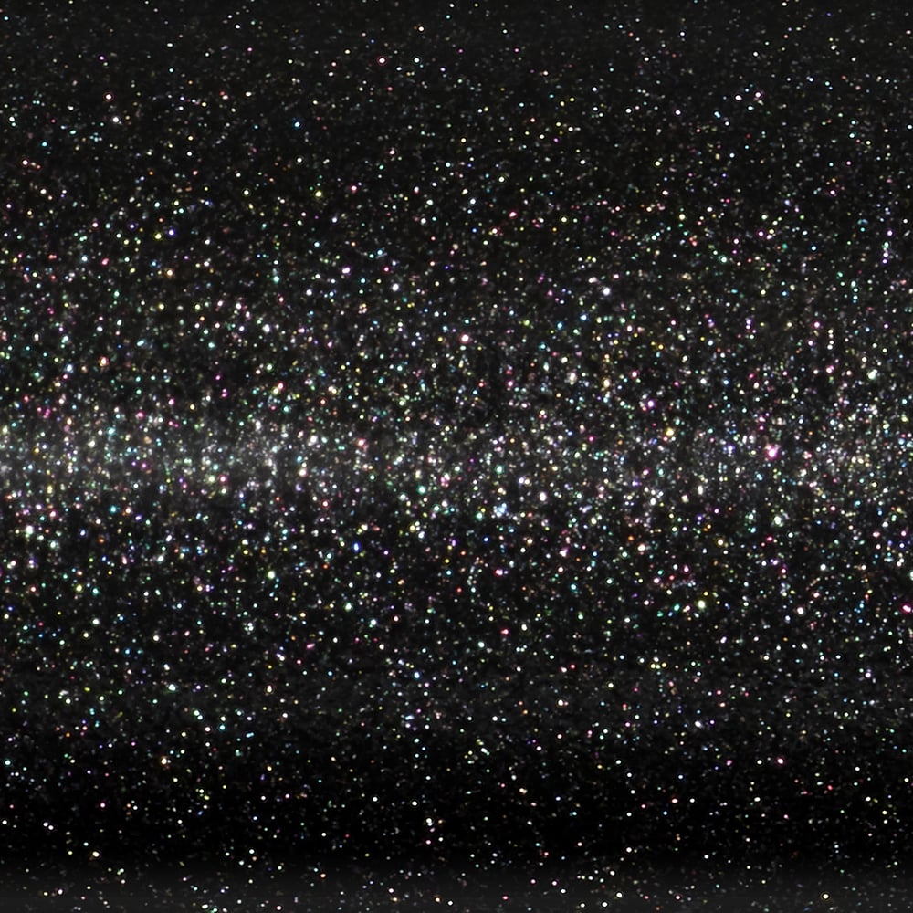 A close-up of a black surface covered in fine, multicolored glitter, reflecting light like the high-modulus graphite finish on a St. Croix Legend Xtreme 6’8” Medium Extra Fast Casting Rod (XFC68MXF) by St. Croix, creating a starry effect.