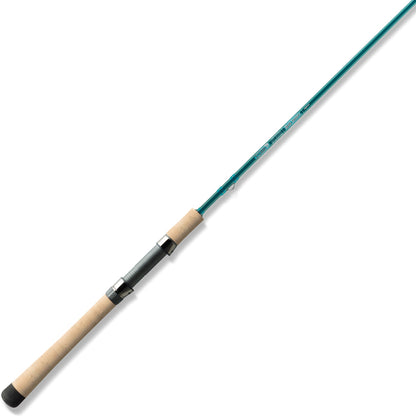 A St. Croix Mojo Inshore Spinning Rod 7'0" Light | JIS70LF is displayed diagonally on a white background, featuring a teal finish, cork handle, metal reel seat, and SCII carbon construction.