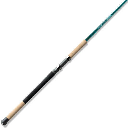 The St. Croix Mojo Inshore Spinning Rod 7'11" Heavy Fast (JIS711HF) features a green shaft, cork handle grips, and metal reel seat—an ideal choice from St. Croix for anglers seeking top-quality saltwater rods. Photographed on a white background.