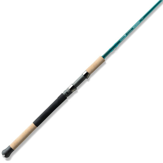 The St. Croix Mojo Inshore Spinning Rod 7'0" Medium Heavy Moderate features a green shaft and cork handle grips, photographed on a white background—perfect for anglers seeking a reliable inshore saltwater rod from St. Croix.