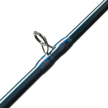Close-up of the St. Croix Triumph Travel Casting Rod 6'6” Medium Heavy (TCR66MHF4), showing a metal guide ring with blue and orange thread wraps on an SCII carbon blank, against a white background.