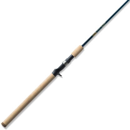 The americanlegacyfishing St. Croix Triumph Casting Rod 7'0" Medium | TCR70MF showcases a long wooden handle and a sleek black reel seat, expertly crafted with premium SCII carbon for enhanced durability. This medium power rod gradually tapers to a slender and flexible tip, ensuring efficient casting and reeling.
