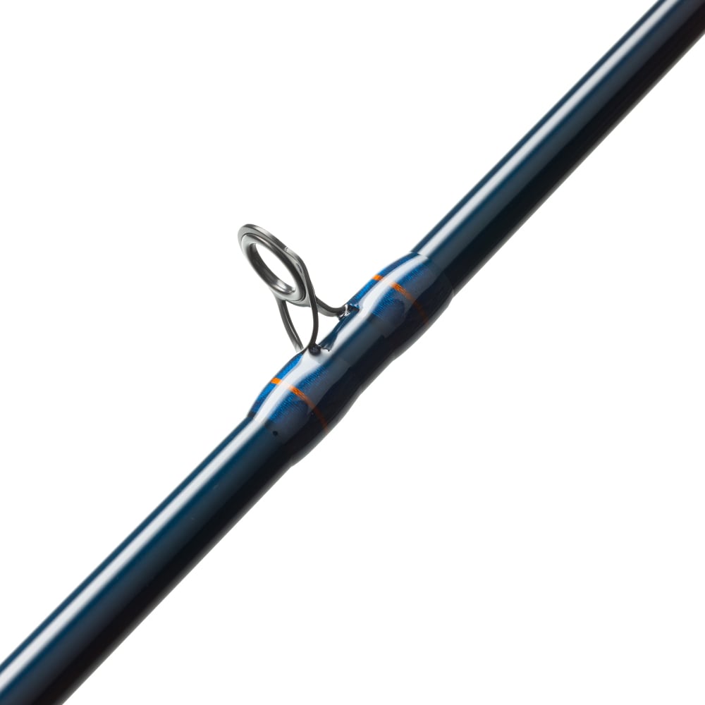Close-up of the St. Croix Triumph Casting Rod 6'6” Medium (TCR66MF), crafted from premium SCII carbon with a blue finish, metal guide ring, and blue-orange thread wrappings against a white background.
