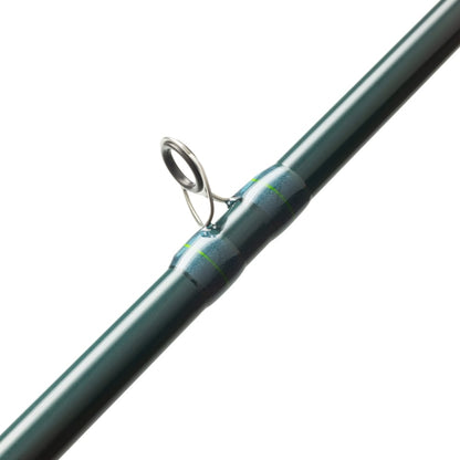 A close-up of the St. Croix Triumph Inshore Casting Rod 6'8” Medium Heavy (TRIC68MHMFSG) by St. Croix highlights a metal guide ring secured with blue and green thread wraps.