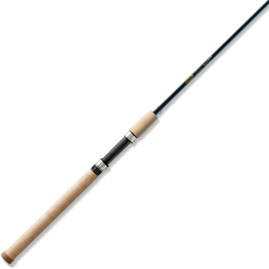 The St. Croix Triumph Salmon & Steelhead Spinning Rod 8'6” Medium Heavy (TRSS86MHF2) features a slender black SCII carbon rod and long, light brown cork handle, shown diagonally on a white background.