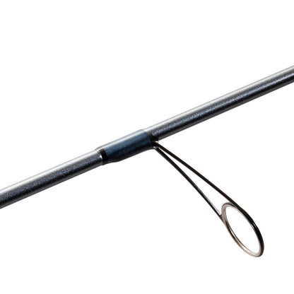 A close-up of the St. Croix Trout Pack Spinning Rod 7'3" Medium Light 3 Piece, highlighting one of the metal line guides attached to the rod, set against a white background.