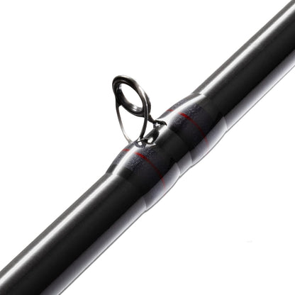 Close-up of a St. Croix Victory Casting Rod, VTC710HF, crafted with SCIII+ carbon fibers, featuring a sleek black finish and metal guide ring. Shiny accents and two red bands enhance its smooth surface, making it perfect for dedicated Bassheads.