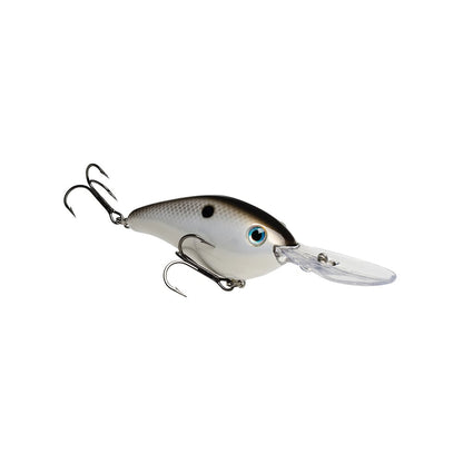 The Strike King 6XD Crankbait, designed for deep diving, features a realistic fish design with a shiny silver body and black eye markings. Its long, clear plastic lip and curved bill ensure effortless diving. Two sharp treble hooks complete this lure against a plain white background.