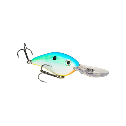 The Strike King 8XD Crankbait is a deep diver with a blue and green top, white belly, two treble hooks, and a clear plastic lip for bass fishing, shown on a white background.