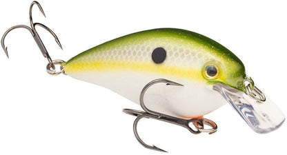The Strike King KVD Squarebill Crankbait, by Strike King, is a fish-shaped lure with a green and yellow top, white belly, black spot, two treble hooks, and clear lip—perfect for shallow water fishing.
