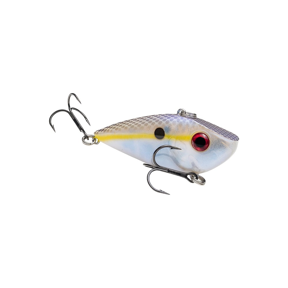 The Strike King Red Eye Shad is a lipless crankbait shaped like a small fish, featuring a white, yellow, and light purple body with a red eye, black dot, and two treble hooks—ideal for professional anglers.
