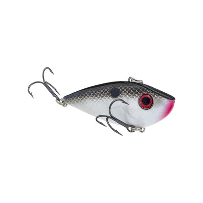 The Strike King Red Eye Shad by Strike King is a realistic lipless crankbait fishing lure with a gray and white body, black top, red eyes, black spot near the fin, pink mouth detail, and two treble hooks underneath and at the tail.