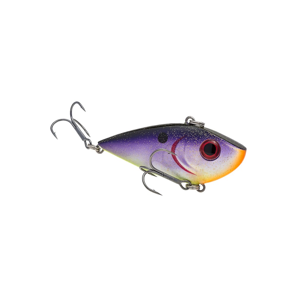 The Strike King Red Eye Shad by Strike King is a lipless crankbait shaped like a small fish, with a purple and yellow gradient body, large red eye, and two treble hooks—one at the rear and one underneath.