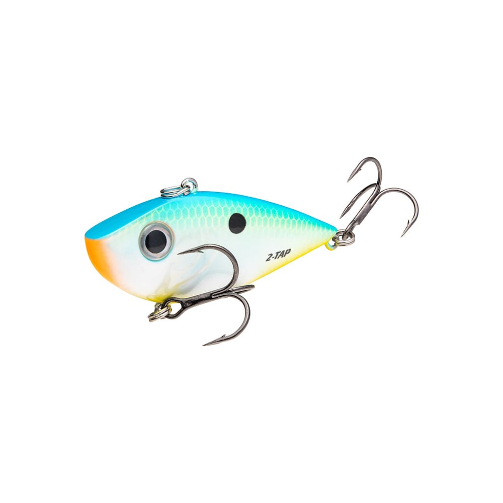 The Strike King Red Eye Shad Tungsten 2 Tap is a dynamic lipless crankbait with a blue-to-yellow gradient and scale-like texture. It features two treble hooks, a black eye dot, and "Z-Tap" lettering, resembling the Strike King Red Eye Shad design.