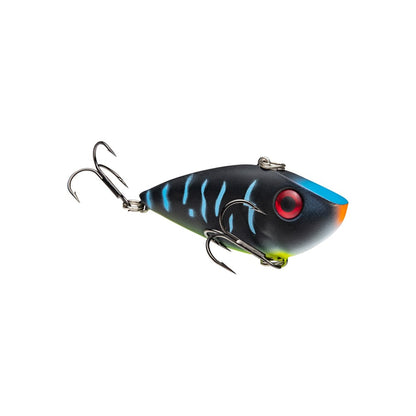 The Strike King Red Eye Shad by Strike King is a colorful lipless crankbait featuring a black body, blue stripes, red eye, orange and yellow accents, and two treble hooks, shown isolated on a white background.