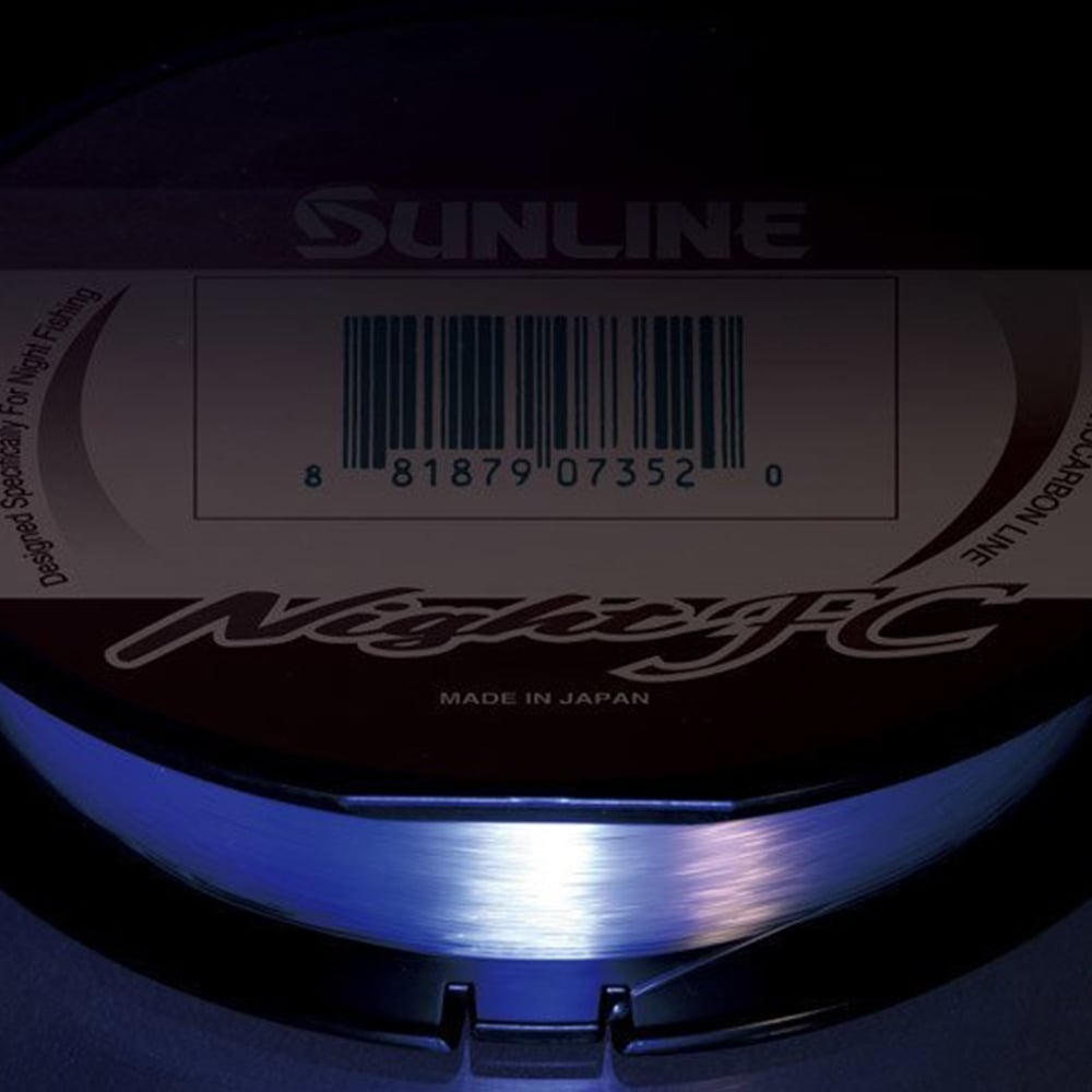 A spool of Sunline Night FC Fluorocarbon Line 165yd from Sunline glows blue under black light, with the label and barcode visible above the reel.