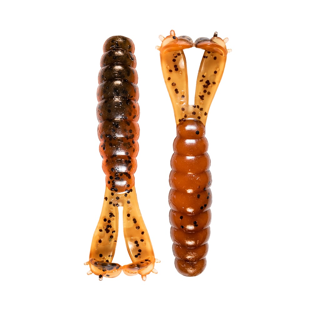 Two brown Z-Man Goat Twin Tail Grub lures with black speckles, made by Z-Man, feature a segmented ElaZtech body and elongated twin paddle-shaped tails. Both are shown against a white background.