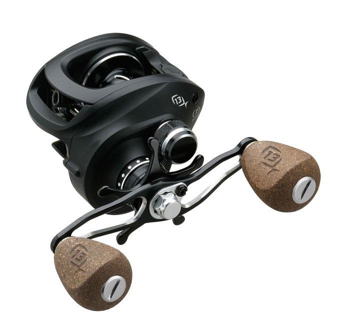The 13 Fishing Concept A 6.6:1 Left Hand Casting Reel features two large cork handle grips and silver accents, shown at an angle against a white background.