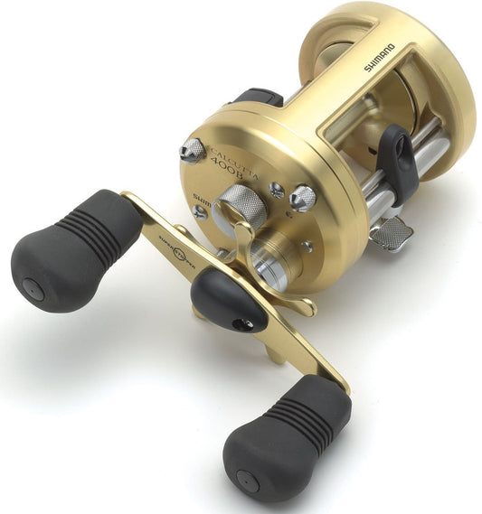 A Shimano Calcutta B 5.0:1 Round Casting Reel CT400B with Dartanium Drag, black rubber handle grips, and visible adjustment knobs is shown on a white background.