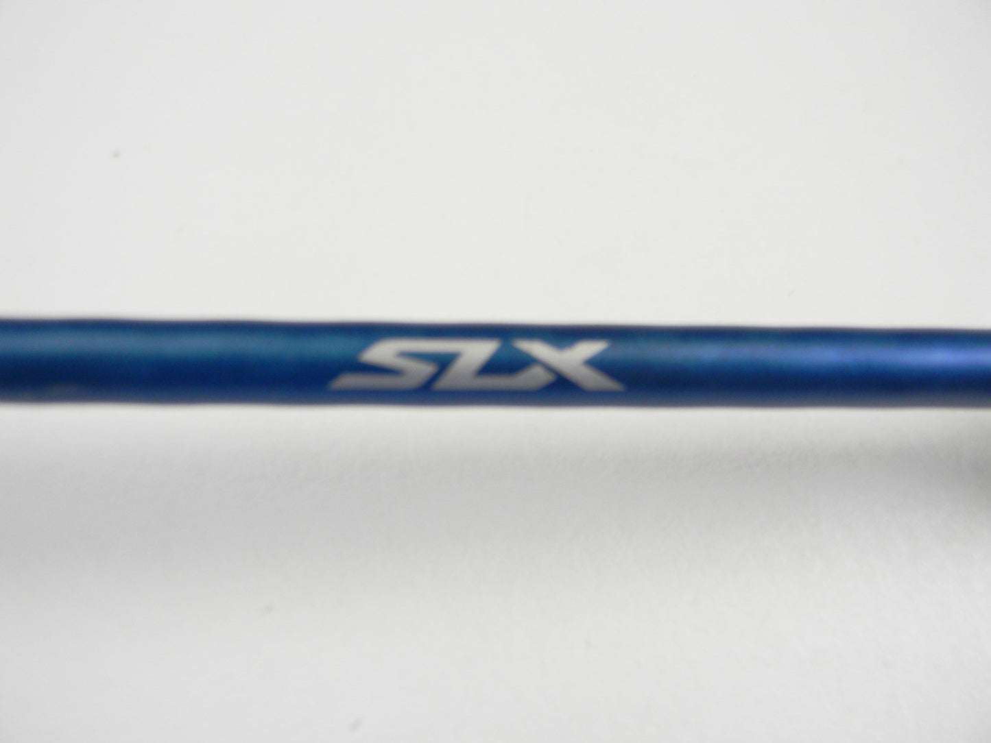 A close-up of a blue Shimano SLX SLXCX610MA 6'10" Medium used casting rod in excellent condition, featuring "SLX" in silver on the surface—ideal for those considering our rod and reel trade-in program.
