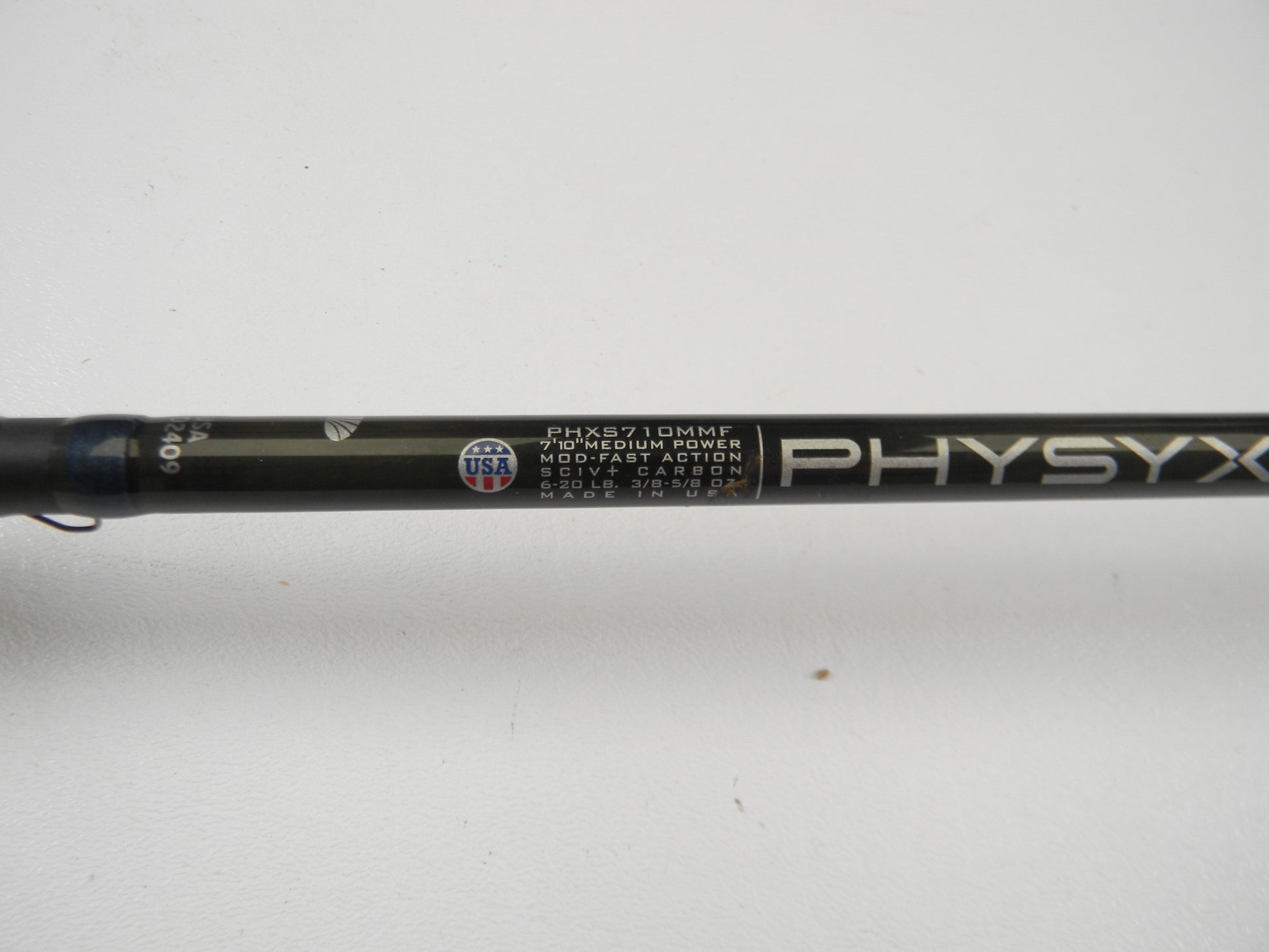 Close-up of a St. Croix Physyx PHXS710MMF 7'10" Medium used spinning rod in very good condition, labeled "PHYSYX," with moderate-fast action—perfect for those upgrading via our rod and reel trade-in program.