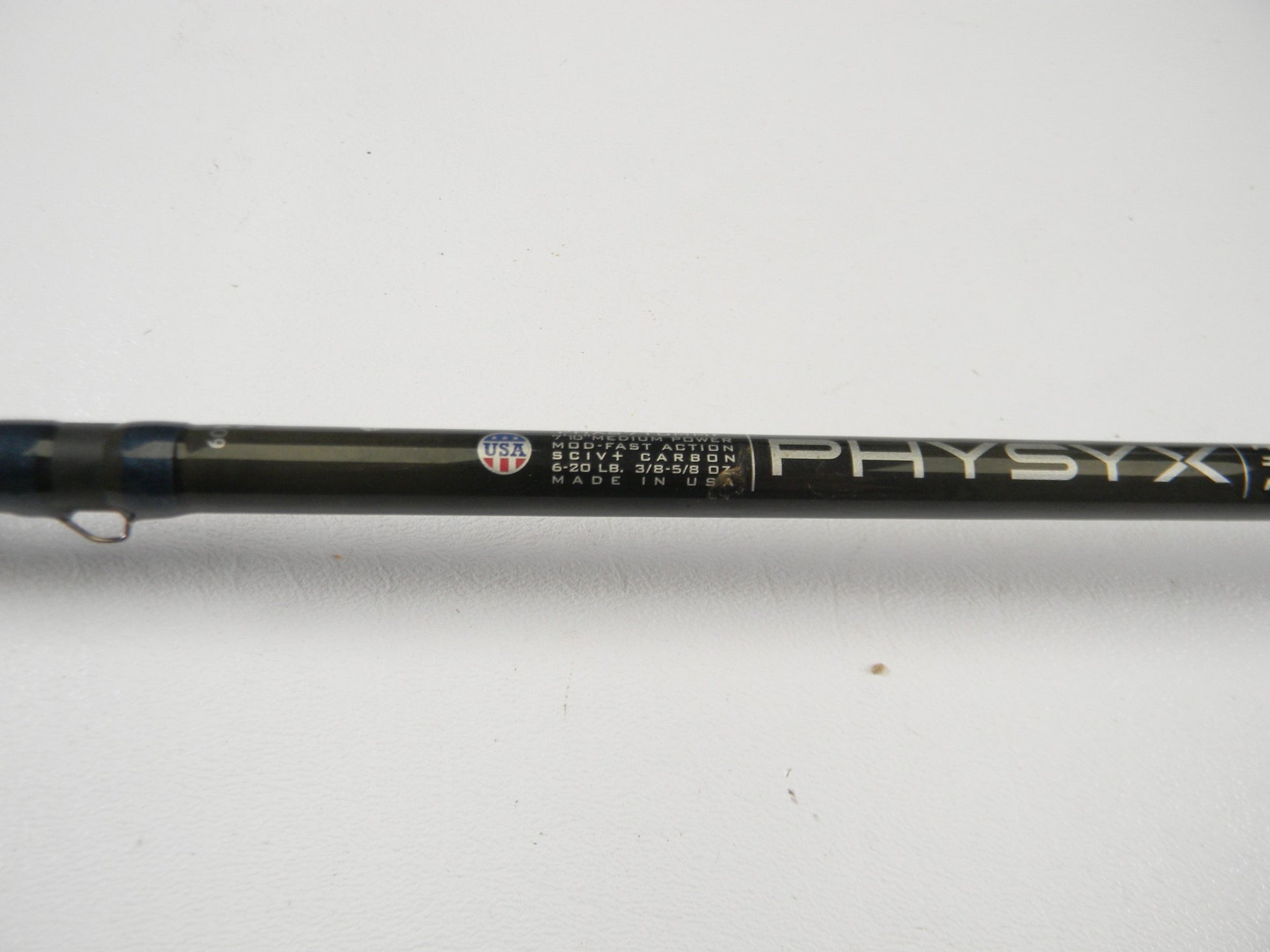 Close-up of a used St. Croix Physyx PHXS710MMF 7'10" medium spinning rod in very good condition on a plain white background. Great for those interested in used gear or wanting store credit through our rod and reel trade-in.