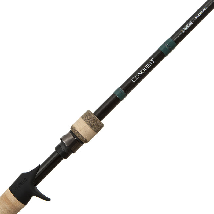 Close-up of the G. Loomis Conquest CNQ 842C MBR Mag Bass Casting Rod handle and reel seat, with cork grips, dark green accents, Shimano branding, and Spiral-X Technology along the shaft.