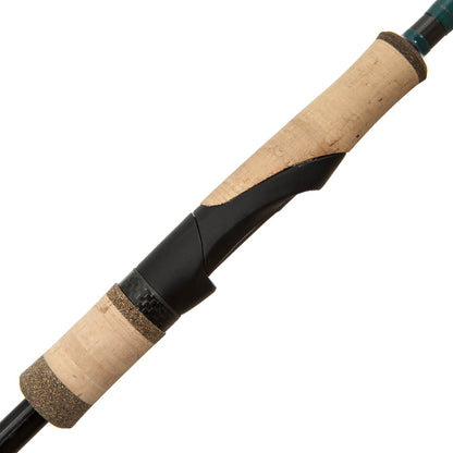 Close-up of the G. Loomis Conquest CNQ 782S SJR Spin Jig Spinning Rod handle, featuring a cork grip, black reel seat, and Spiral-X Technology, shown diagonally on a white background.