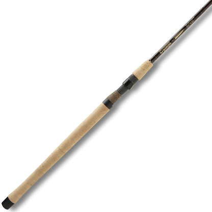 The G. Loomis Salmon Float Spinning Fishing Rod STFR1262 features a long light brown cork handle, black reel seat, and dark blank. Medium-light action offers precise casting and control on small rivers. Shown on a plain white background.
