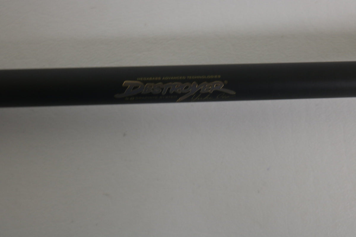 A close-up of a Megabass Destroyer P5 F7.1/2-76X Used Casting Rod in excellent condition, featuring "Destroyer" and other gold lettering on the black rod, set against a plain white background.