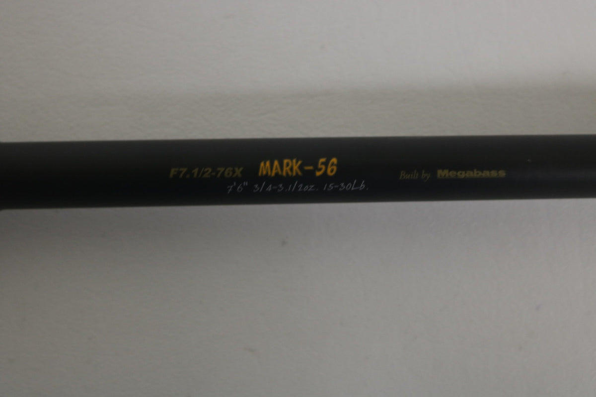 A close-up of the Megabass Destroyer P5 F7.1/2-76X Used Casting Rod, showing yellow and white model text on its black finish, with a plain light background. Brand: Megabass. Condition: Excellent.