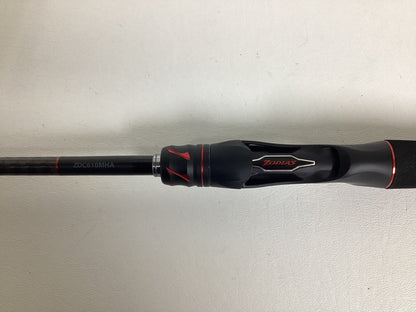 Close-up of a Shimano Zodias rod handle in black and red, ideal for the Nation's Best Rod and Reel Trade-In Program. The reel seat has red detailing with "Zodias" branding, while the rod section shows "ZDC610MHA" against a light background.