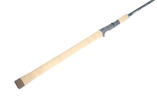 A close-up of the G. Loomis IMX-Pro 966C SWBR Used Casting Rod handle by G. Loomis, featuring a light cork grip and gray reel seat, shown against a white background.