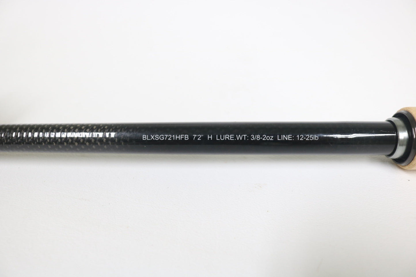 A close-up of the Daiwa BLX SG721HFB 7'2" Heavy Used Casting Rod in very good condition, featuring a textured grip, metallic ring near the handle, and white printed specs. Great for anglers or trading up through our Rod and Reel Trade-In Program.
