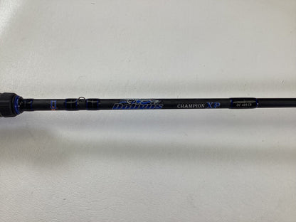 A close-up of a black Dobyns Champion XP DC685CB casting rod in excellent used condition, featuring blue and white lettering on a white background.