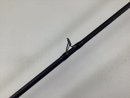 A close-up of the Dobyns Champion XP DC685CB Used Casting Rod in excellent condition, featuring a black finish and metal line guide, shown against a plain white background.