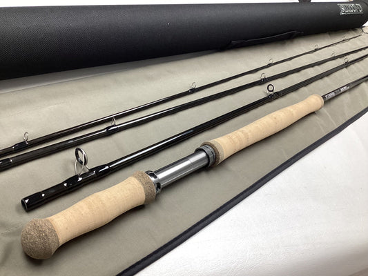 The G. Loomis IMX-PRO V2 Shortspey 3111-4 11'1" #3, a mint condition used fly rod, is displayed with its black case—perfect for customers interested in our trade-in program for store credit or gently used gear.