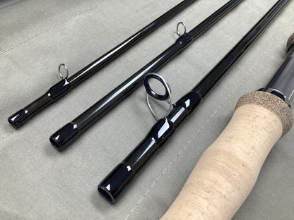 Close-up of a G. Loomis IMX-PRO V2 Shortspey 3111-4 11'1" #3 used fly rod in mint condition, featuring metal line guides and cork handle—ideal for those upgrading via our rod and reel trade-in program.