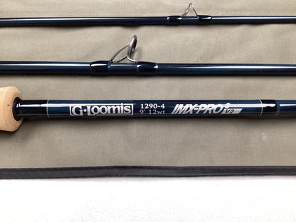 Three sections of the G. Loomis IMX-PRO V2S Saltwater 1290-4 9'0" #12 Used Fly Rod (mint condition) are displayed on gray fabric—ideal for those interested in our Rod and Reel Trade-In Program or quality pre-owned gear.