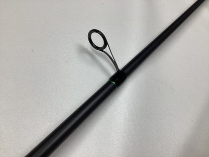 A close-up of the G. Loomis IMX-PRO Steelhead Centerpin Rod 1361-2CP STR 11'4" Medium Light (Used, Mint Condition), highlighting one of its line guides on a smooth, light-colored surface.