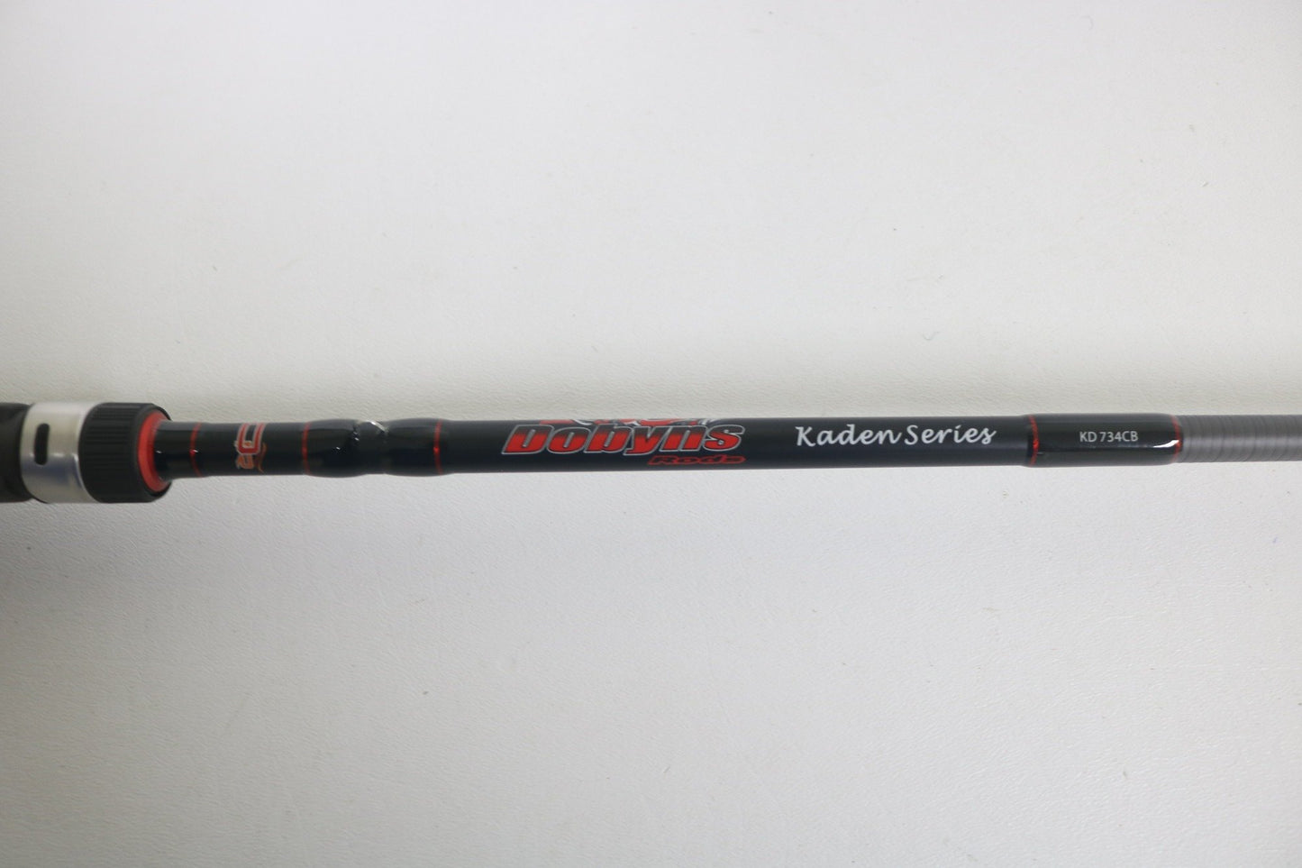 A close-up of a Dobyns Kaden KD734CB 7'3" Medium Mod-Fast casting rod in excellent used condition, featuring the Dobyns branding against a plain white background.