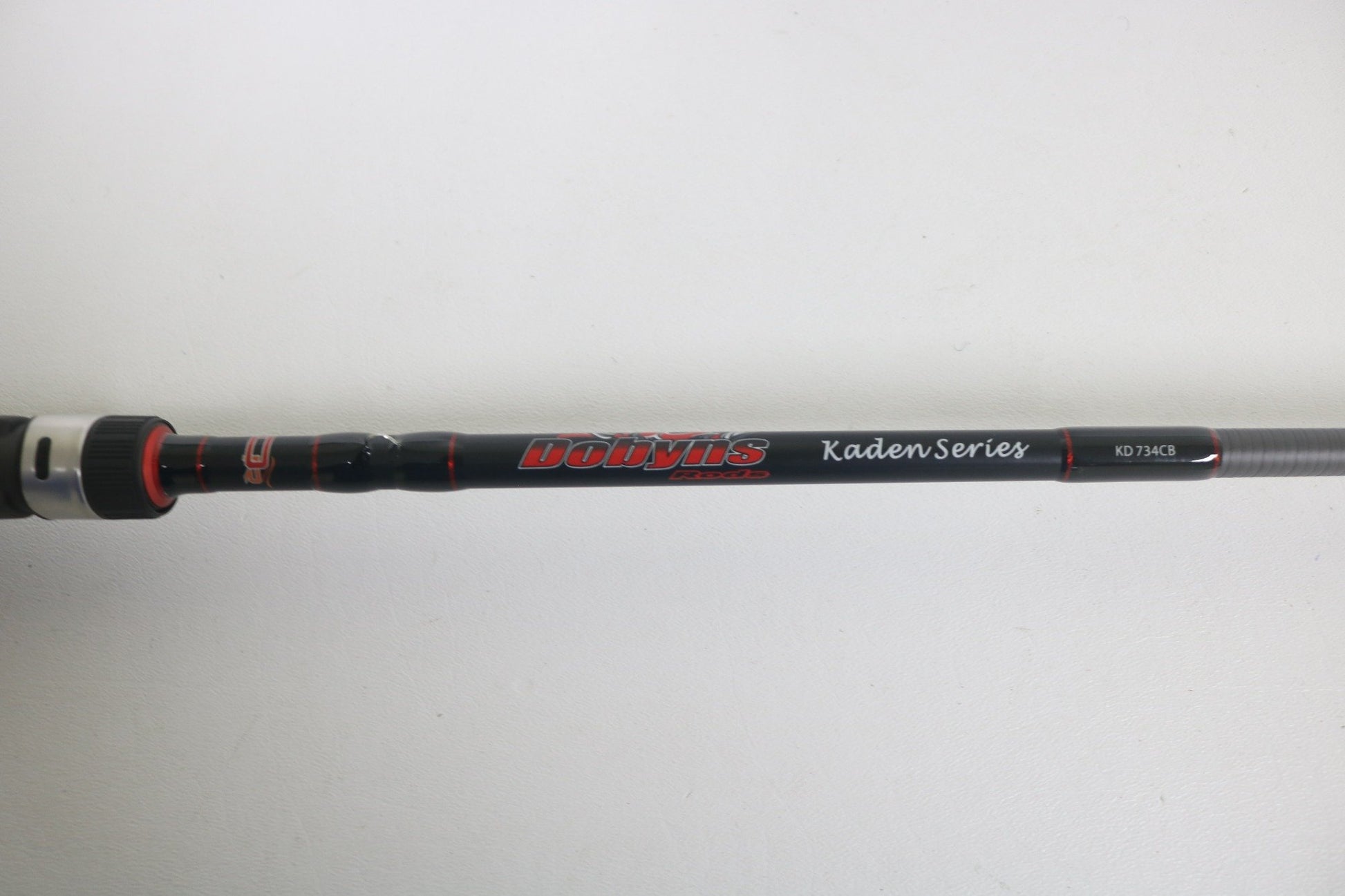 A close-up of a Dobyns Kaden KD734CB 7'3" Medium Mod-Fast casting rod in excellent used condition, featuring the Dobyns branding against a plain white background.