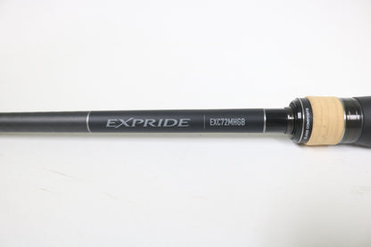 A close-up of a Shimano Expride B EXC72MHGB 7'2" Medium Heavy Glass Casting Rod in excellent used condition, featuring a black and tan handle—ideal for anglers considering our rod and reel trade-in program.