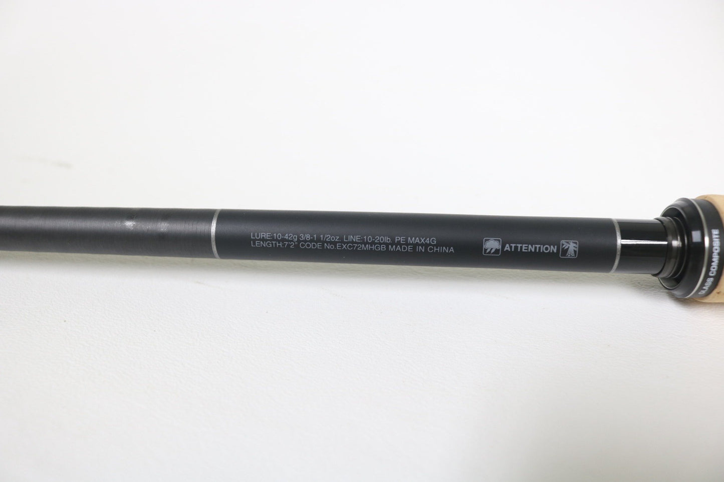 A close-up of the Shimano Expride B EXC72MHGB 7'2" Medium Heavy Glass casting rod shows specs on the shaft, ideal for those trading in used Shimano gear for store credit. This rod is in excellent condition and ready for your next adventure.