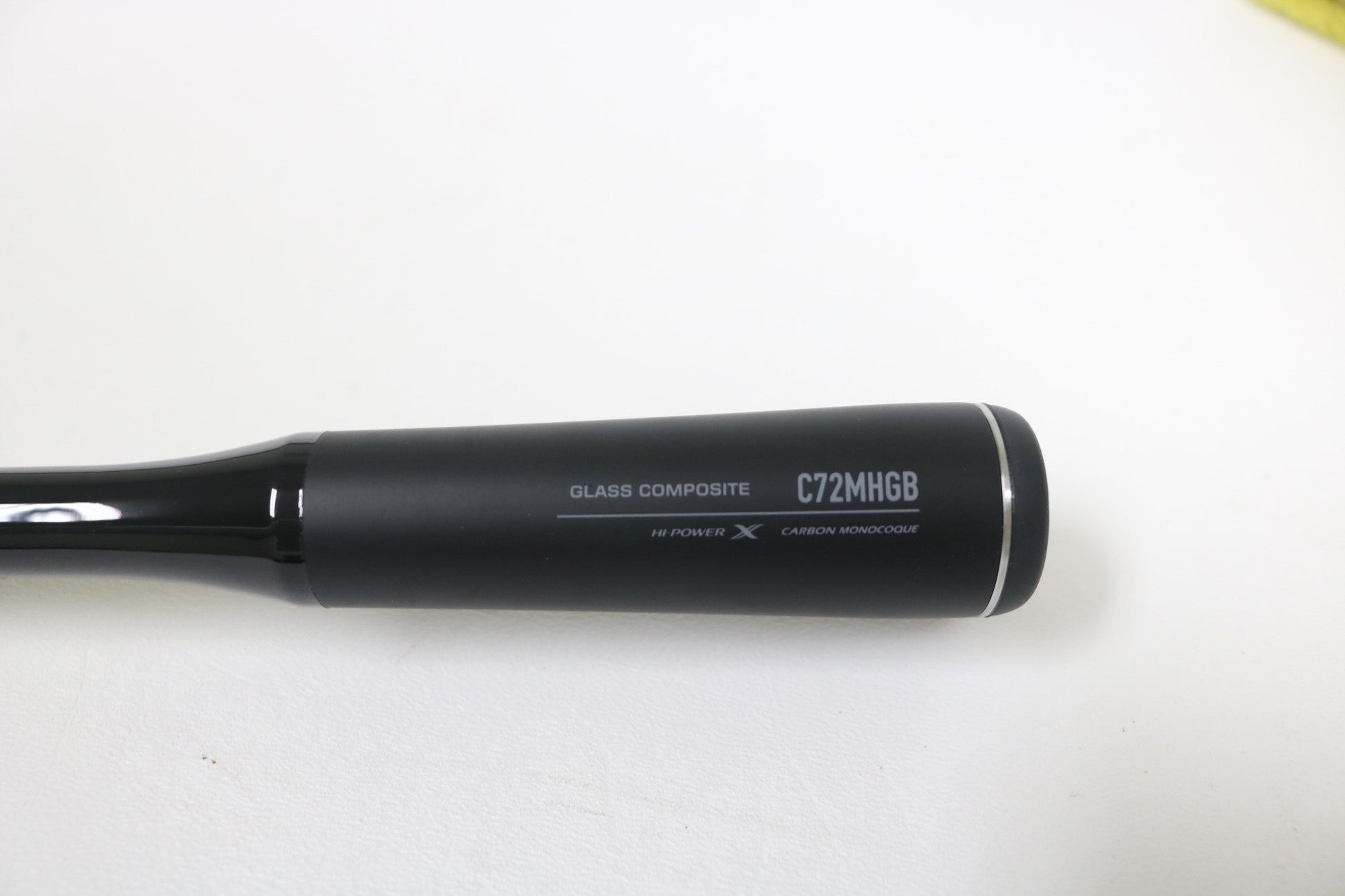 A close-up of the Shimano Expride B EXC72MHGB 7'2" Medium Heavy Glass casting rod handle, labeled "HI-POWER X CARBON MONOCOQUE," ideal for anglers seeking quality used gear from Shimano.